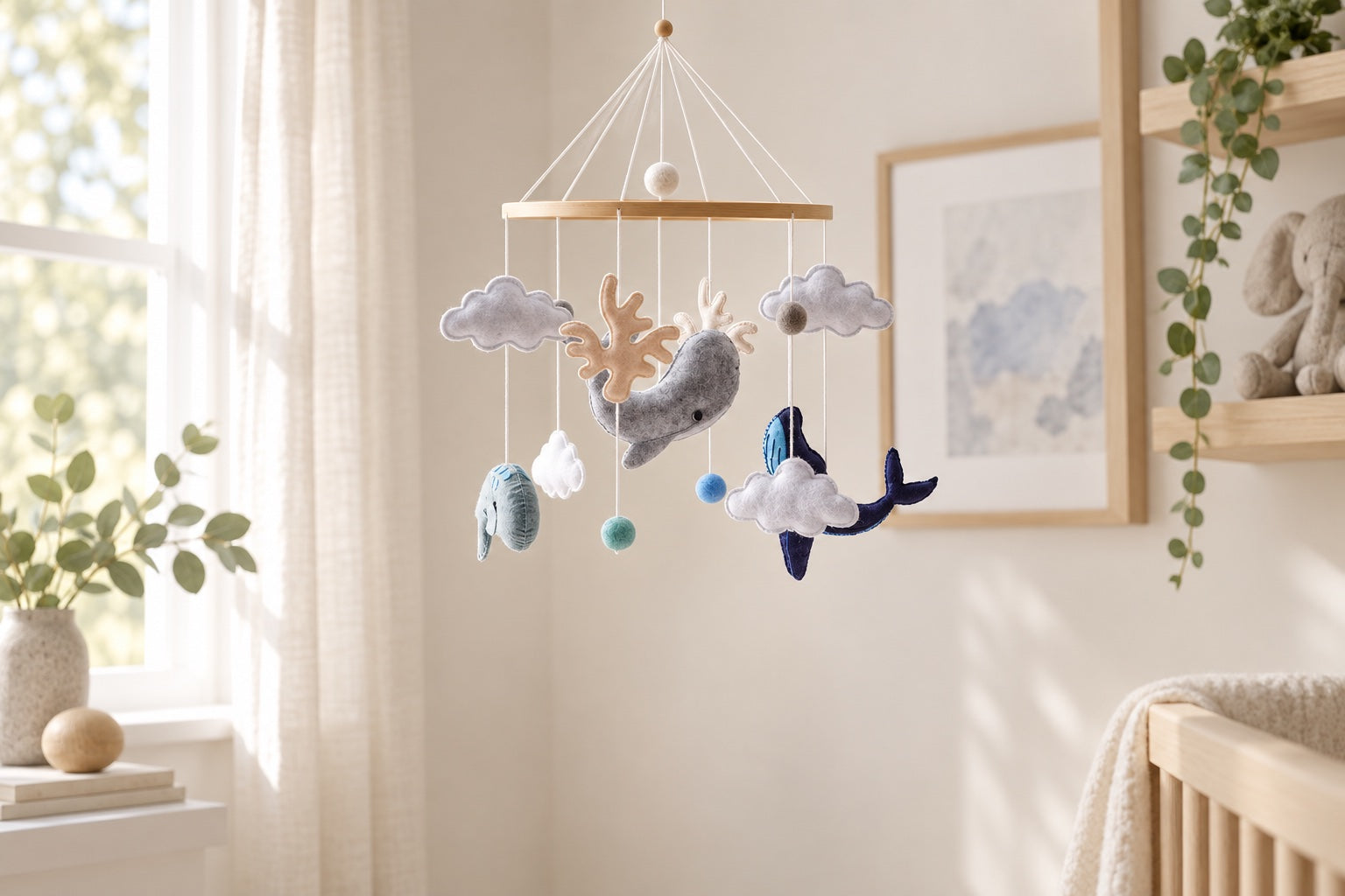 A soft whale mobile hanging in a nursery